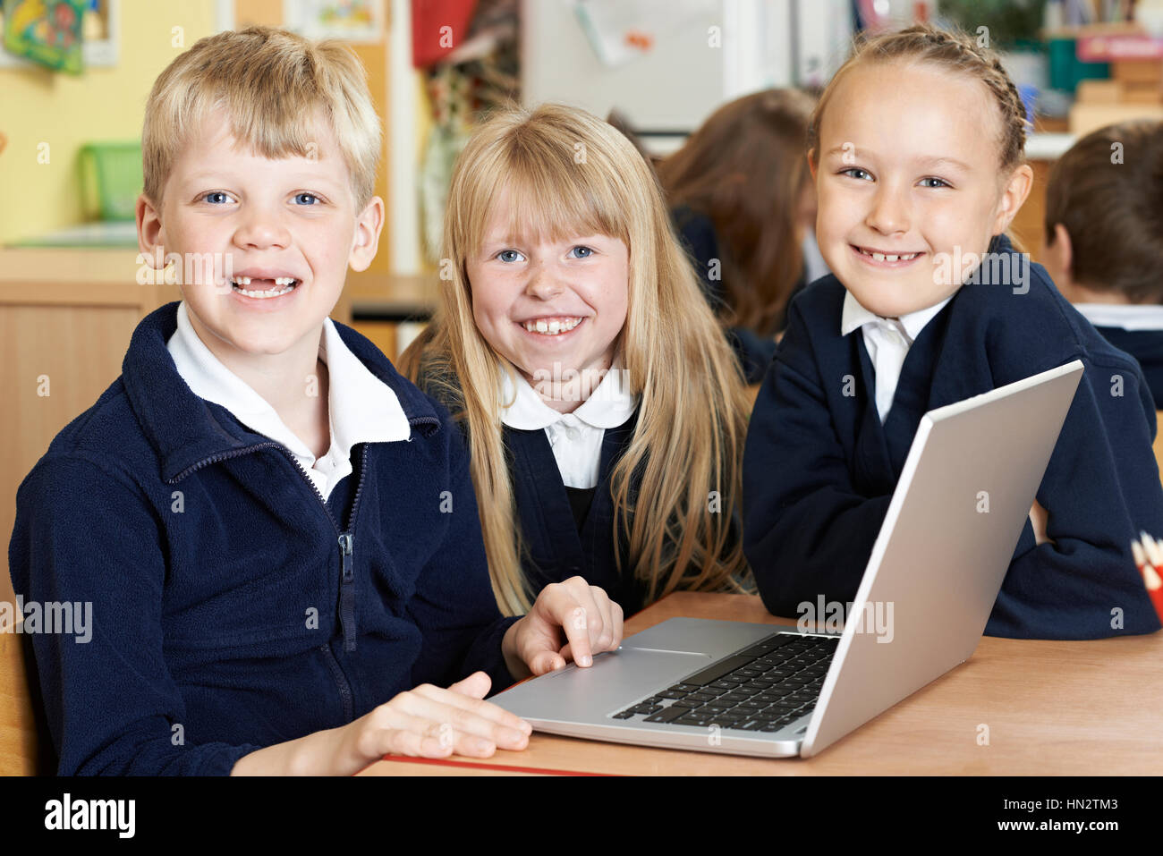 Group Of Elementary School Children Working Together In Computer Class Stock Photo