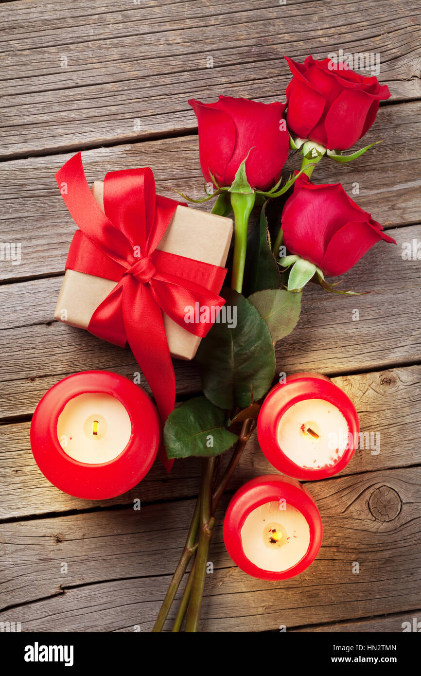 Valentines day greeting card, red rose flowers, candles and gift box on ...