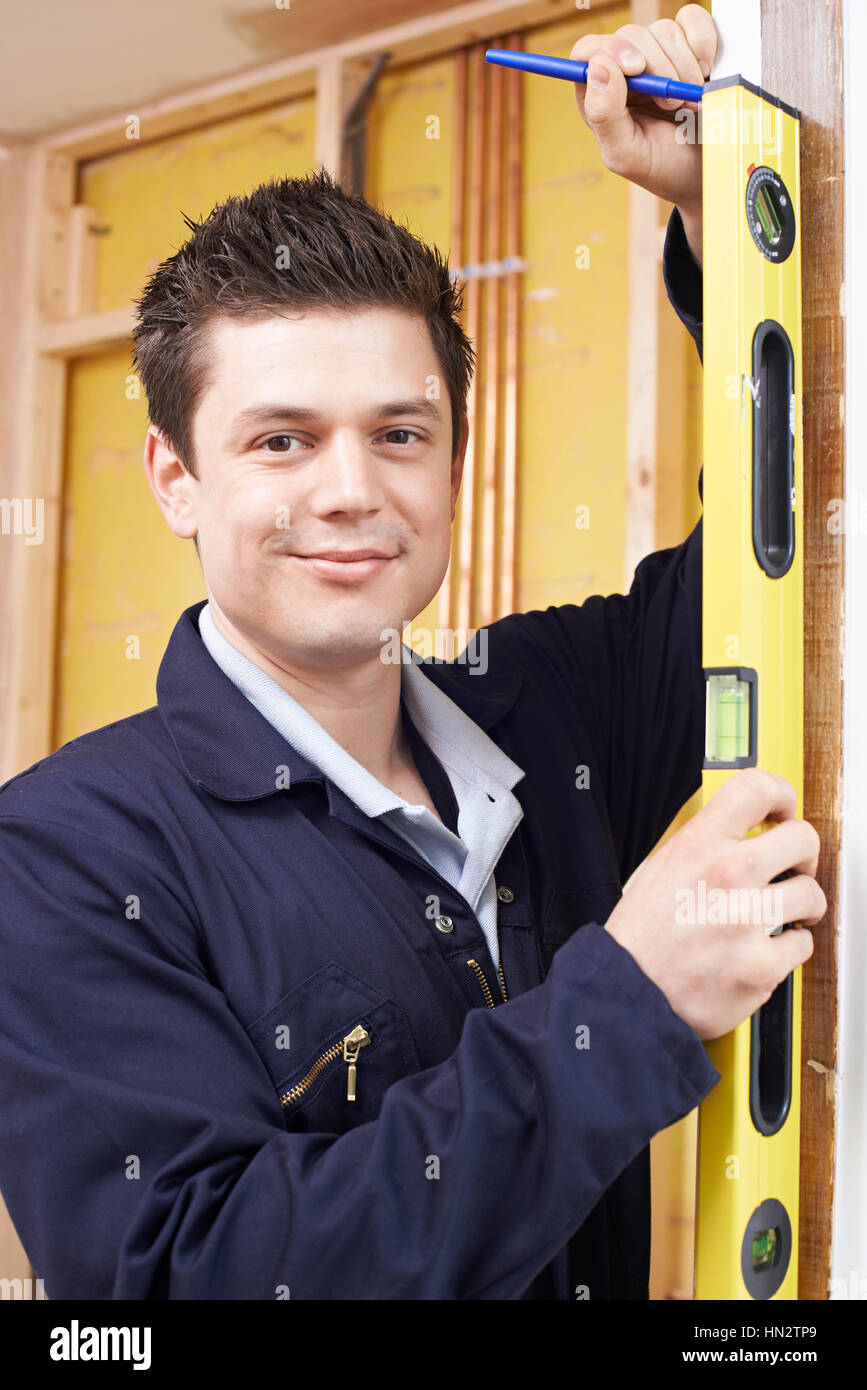 Portrait Of Builder Checking Work With Spirit Level Stock Photo - Alamy