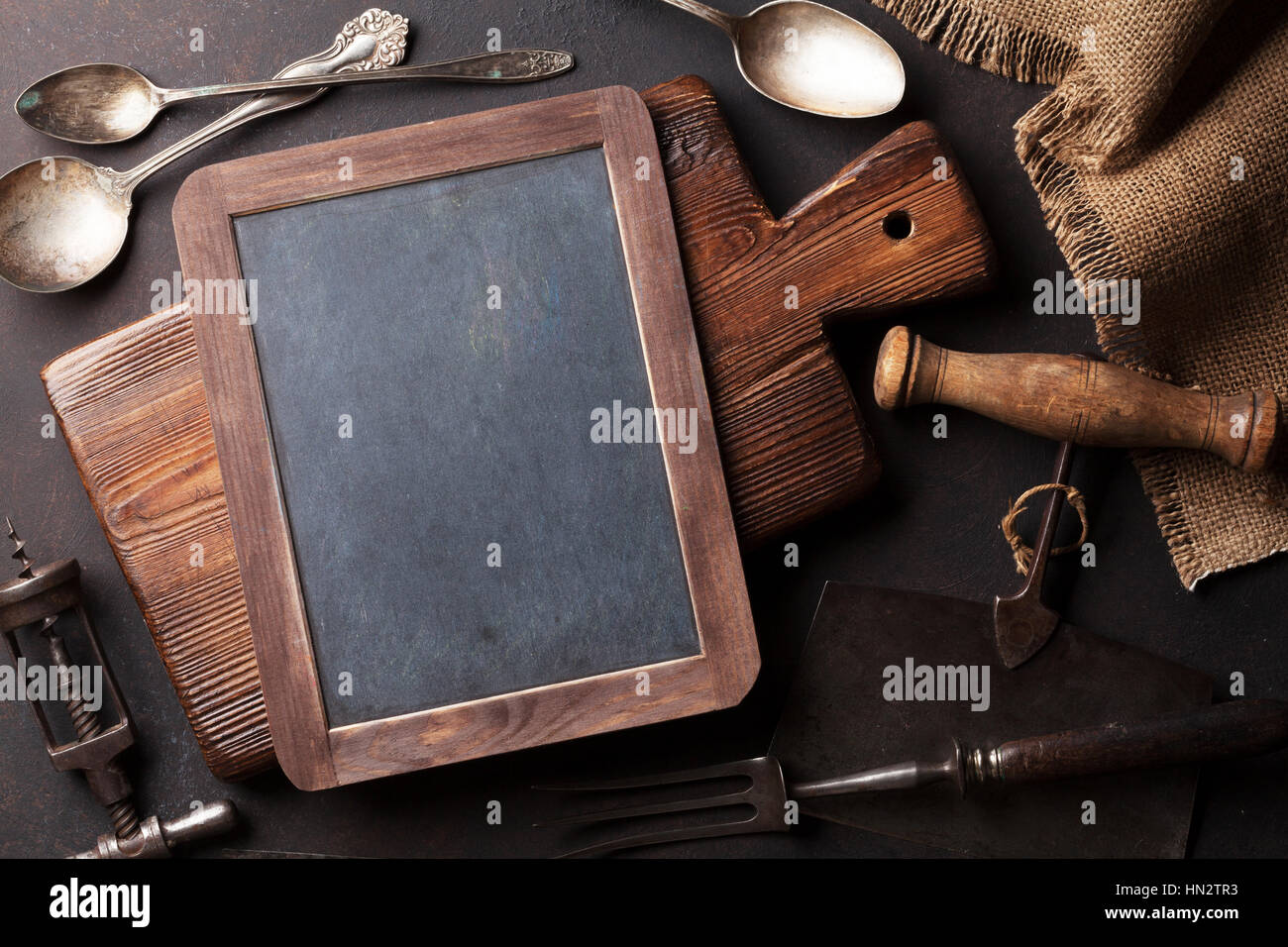 Old vintage kitchen utensils. Fork, knife, spoons, cutting board. Top