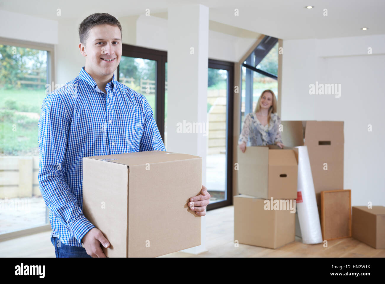 Young Couple Moving Into New Home Together Stock Photo - Alamy