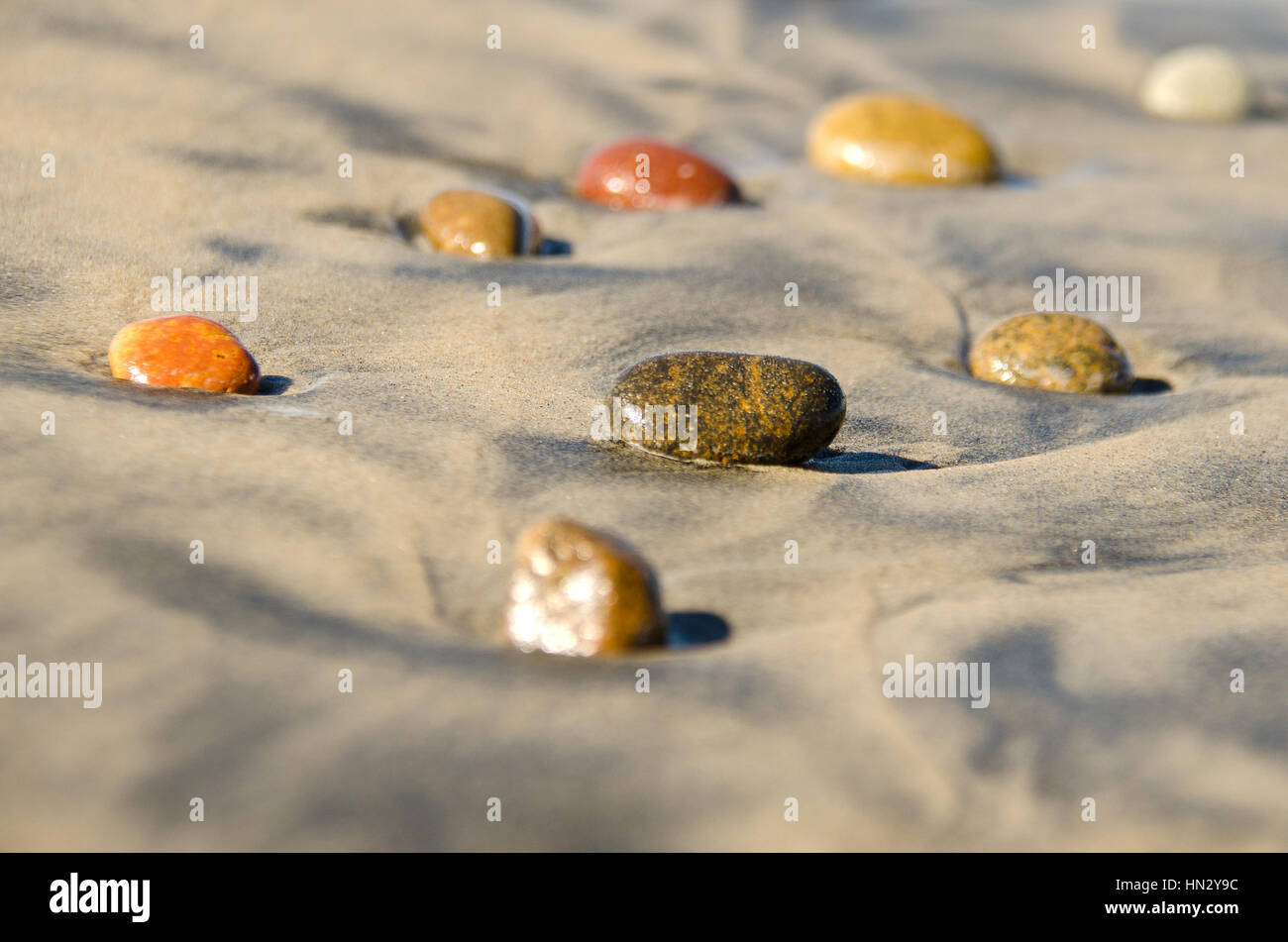 Pebbles stones on sand at the beach Stock Photo
