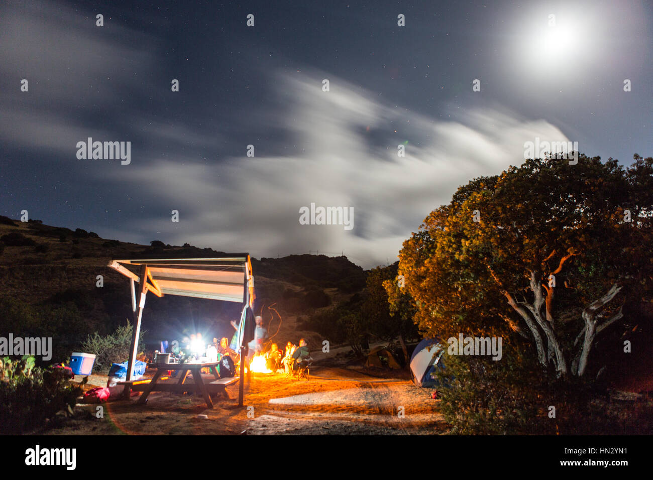 Campers gather around a campfire at Two Harbors, Catalina Island. Stock Photo