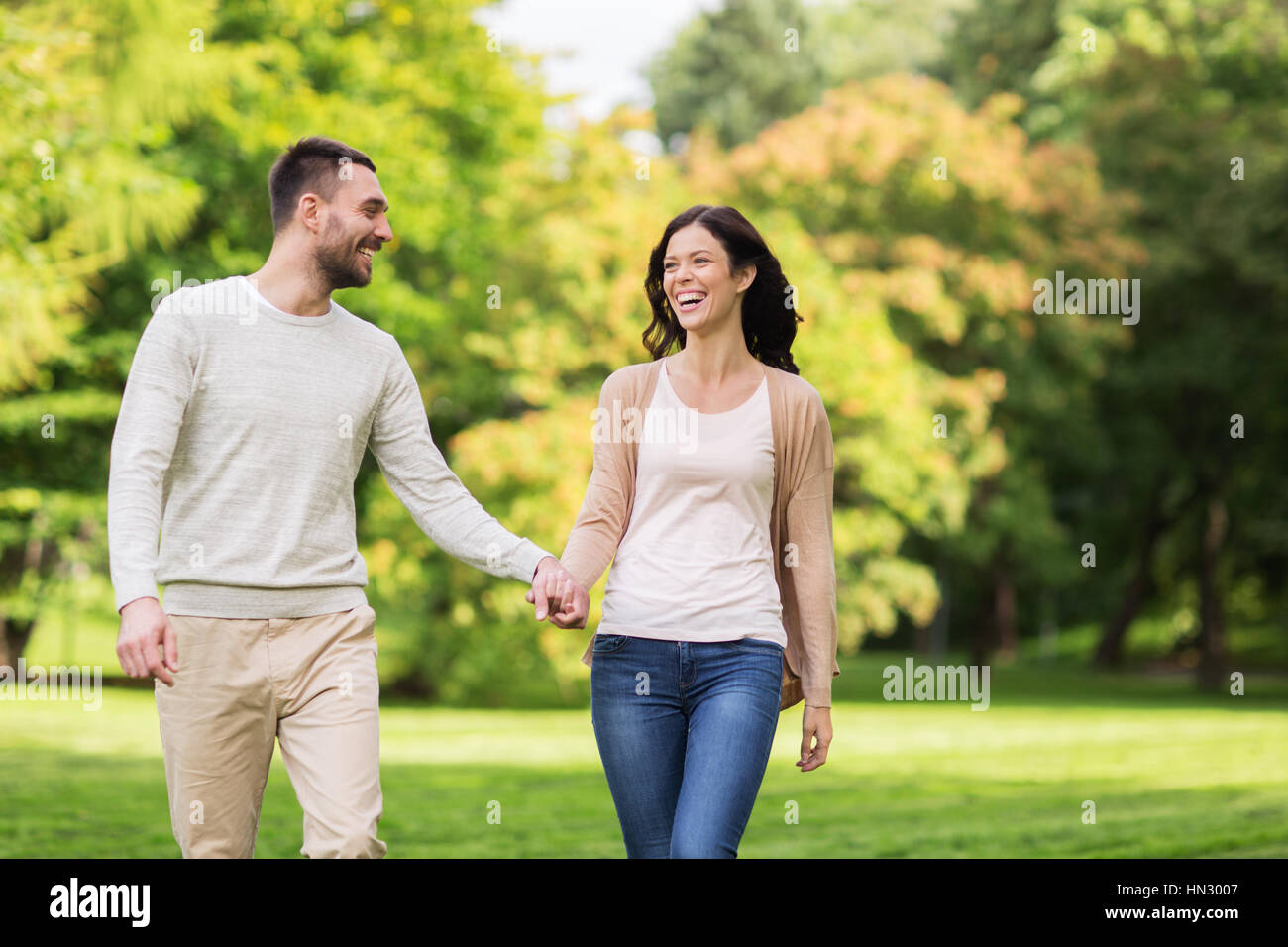 happy couple walking in summer park Stock Photo - Alamy