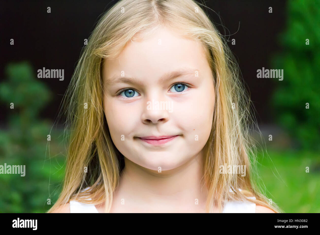 Cute girl with blond long hair and blue eyes Stock Photo - Alamy