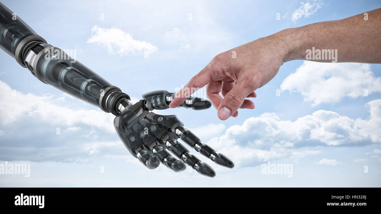Hand of man pretending to touch an invisible screen against sky Stock Photo