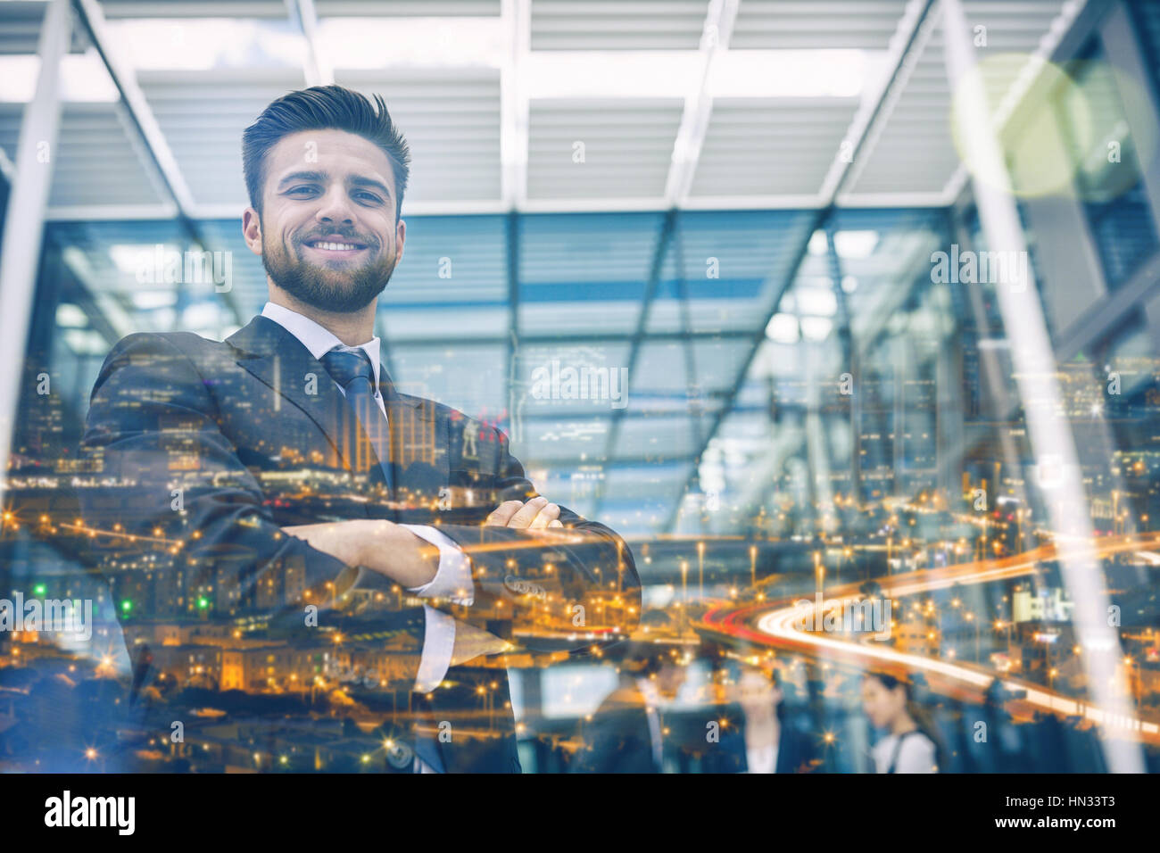 Portrait of businessman smiling with arms crossed Stock Photo - Alamy