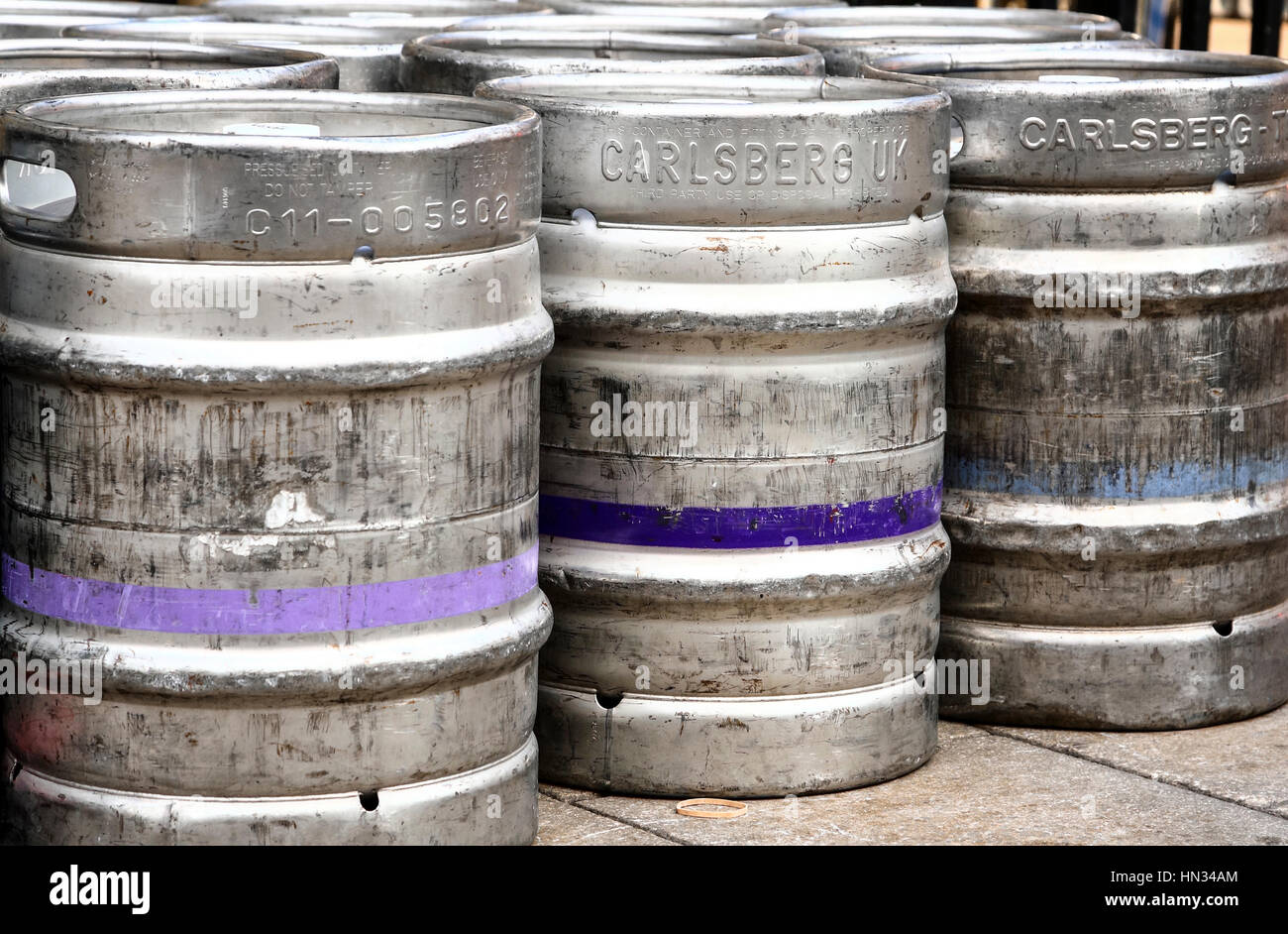 Aluminium beer real ale,lager kegs (barrels) stacked on the pavement in the city of leeds uk after a brewery delivery to a pub Stock Photo