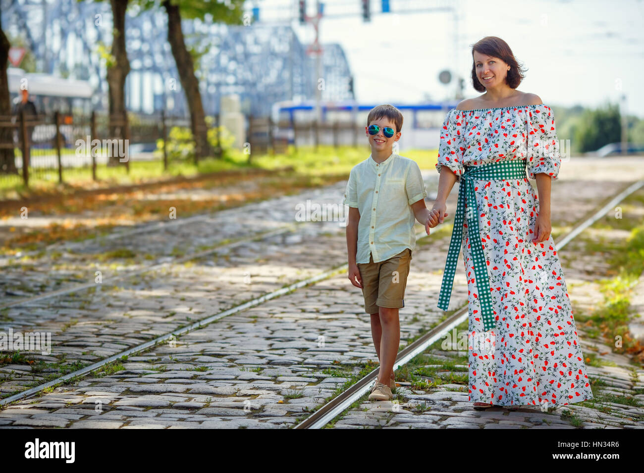 Young mother and her son walking outdoors in city Stock Photo