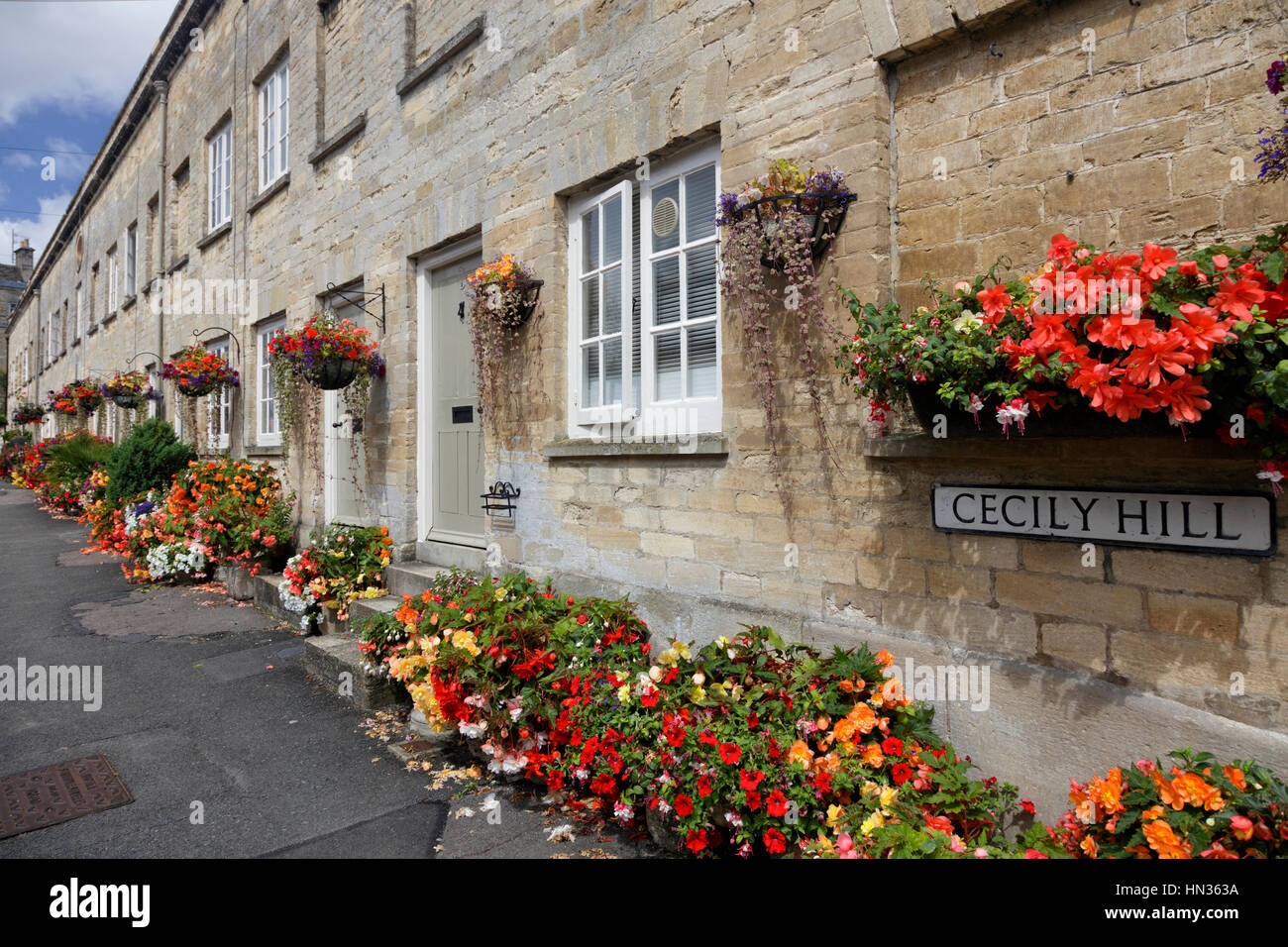 A Row Of Cotswold Stone Terraced Cottages Near To Cirencester Park