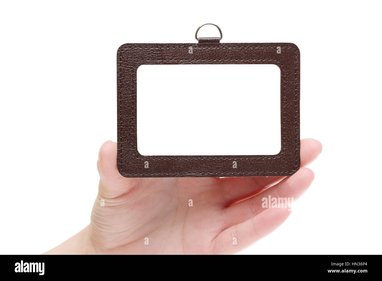 Hand holding blank identification badge isolated on white background