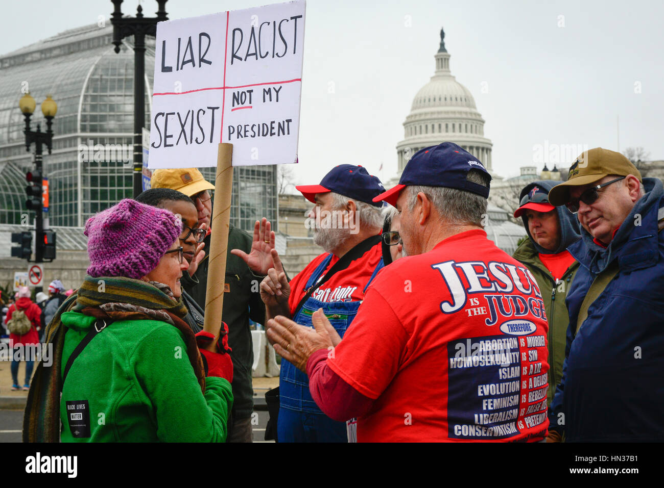 Protesters at Women's March on Washington, DC on January 21, 2017 get into arguments with Religious evangelical demonstrators Stock Photo
