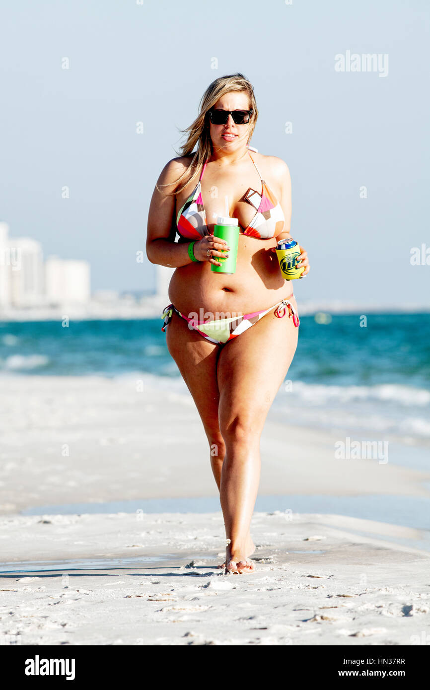 Attractive full figured woman walking on a beach. Stock Photo