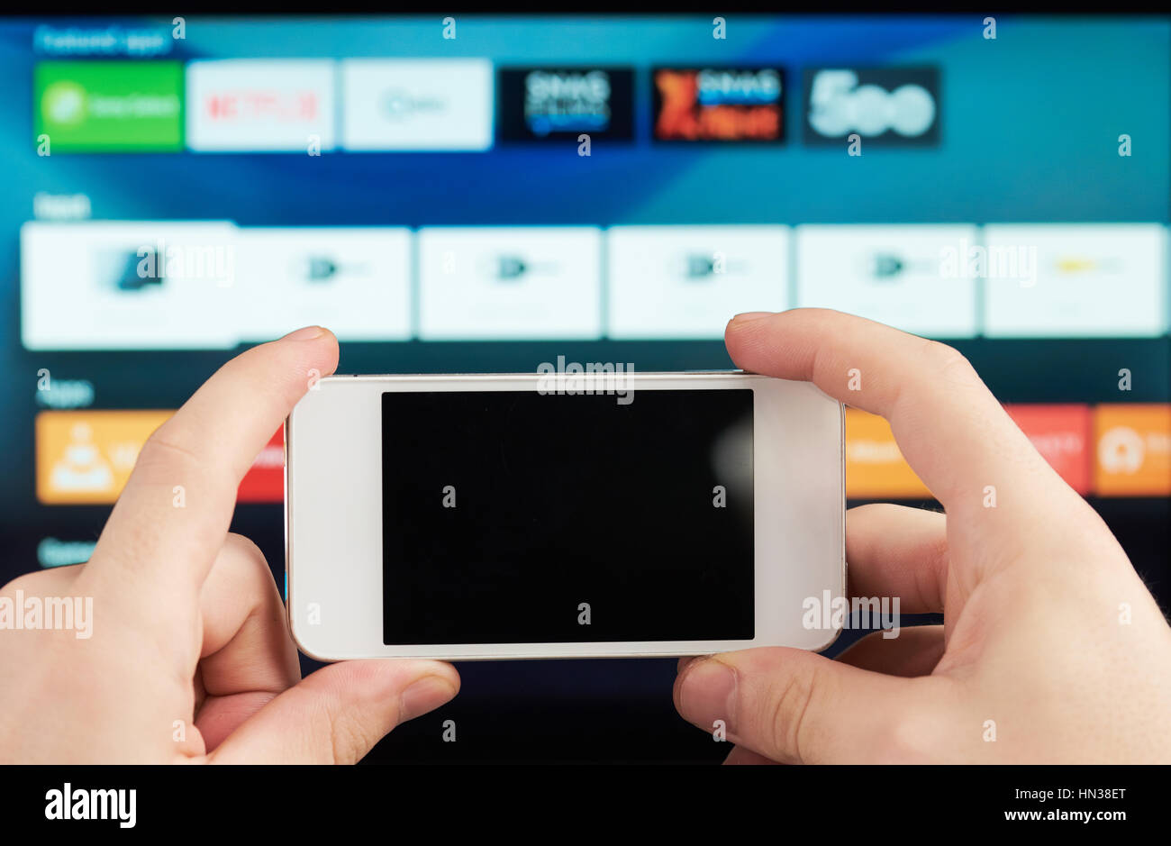 close up of phone as remote for smart tv Stock Photo