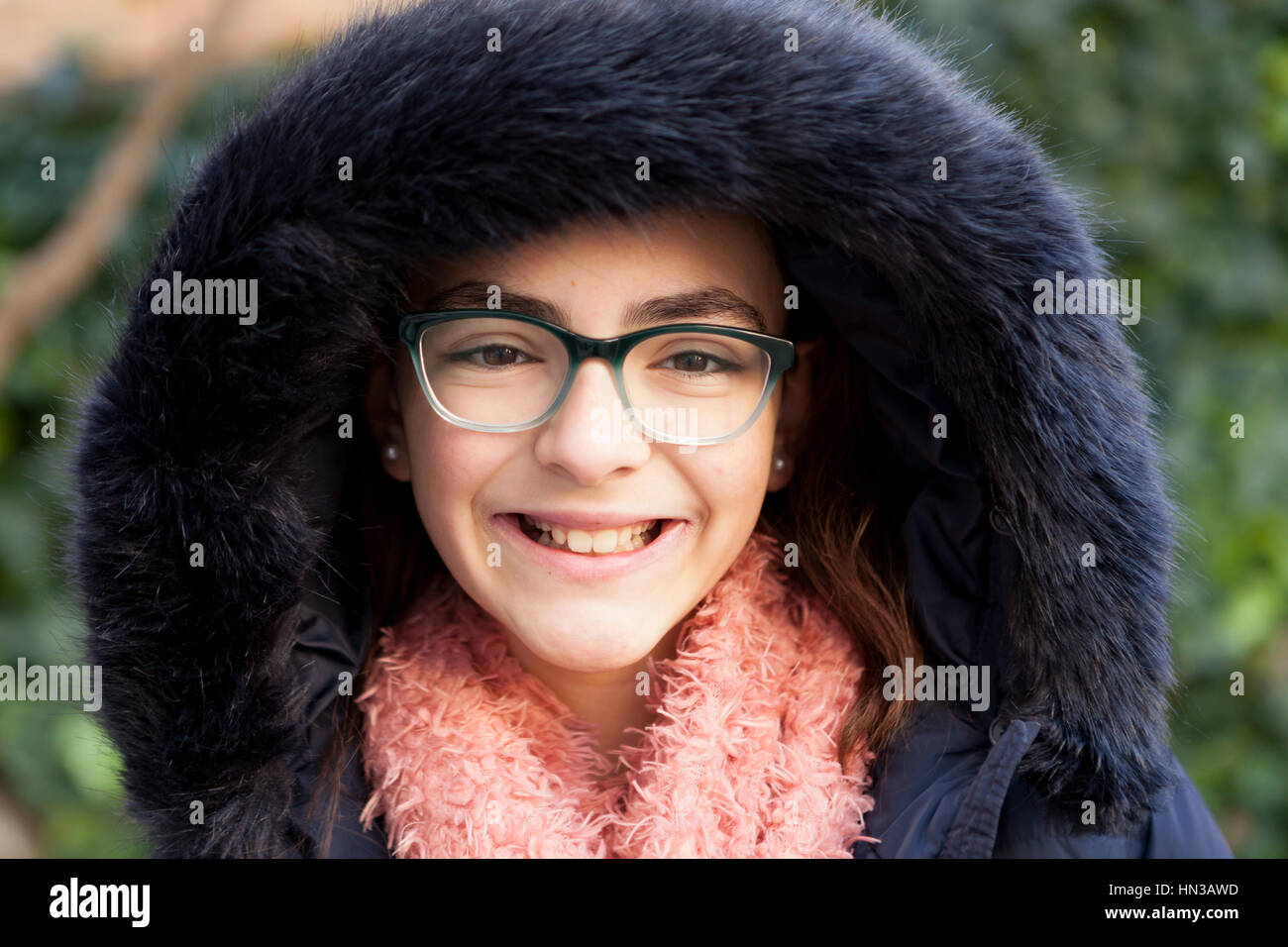 Smiling preteen girl in the garden at winter Stock Photo