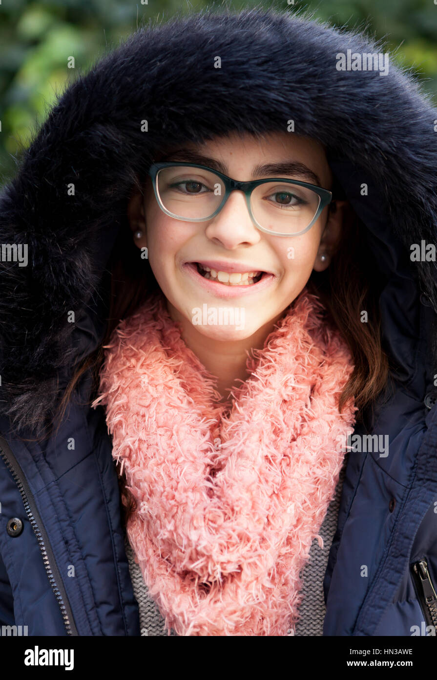 Smiling preteen girl in the garden at winter Stock Photo