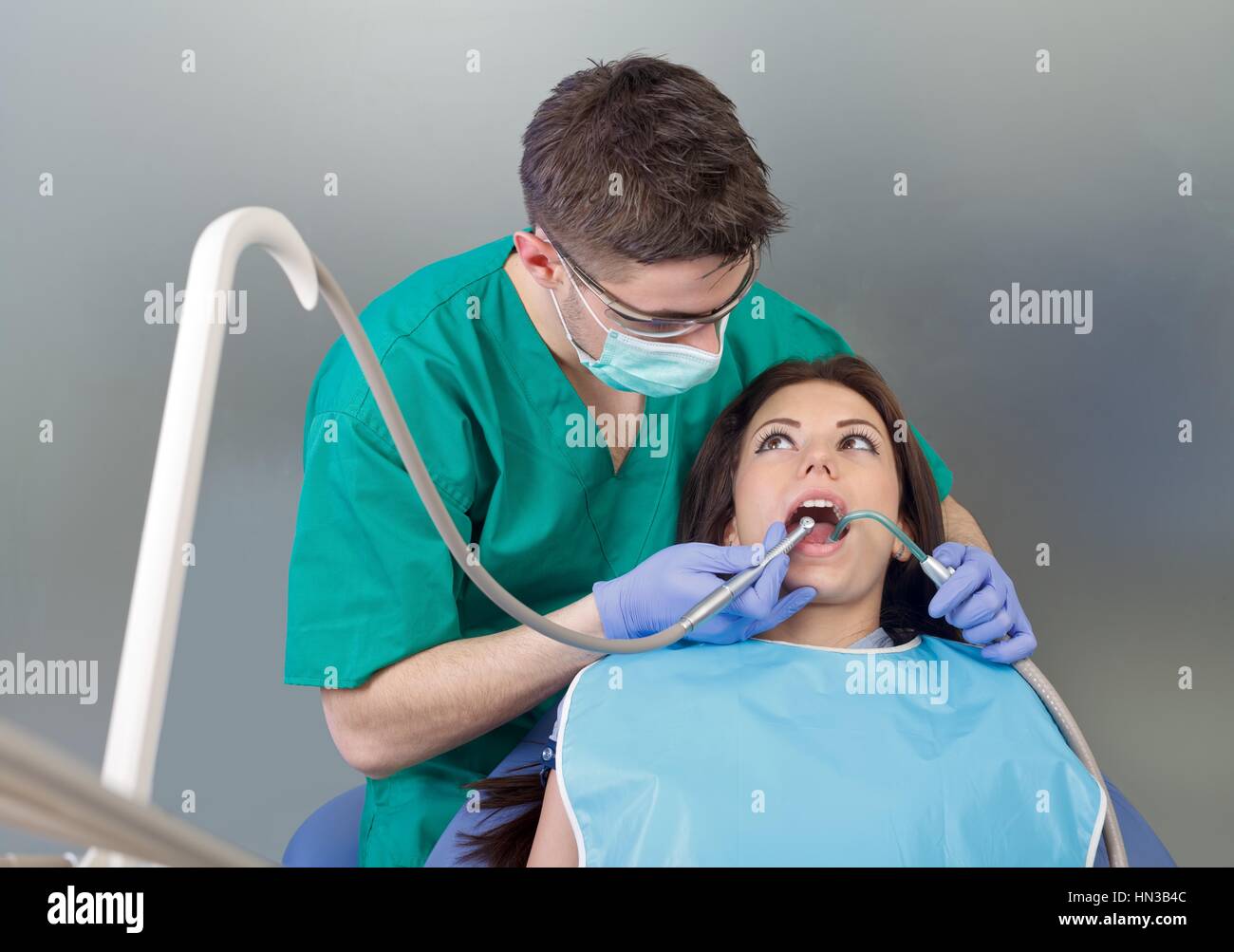 The confident dentist drilling the patient's teeth Stock Photo Alamy