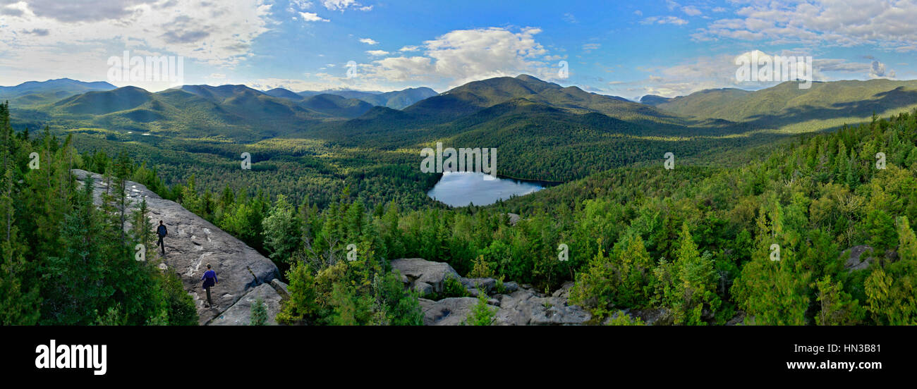 Distant View Of Hikers On The Summit Of Mount Jo In Adirondack Park Stock Photo
