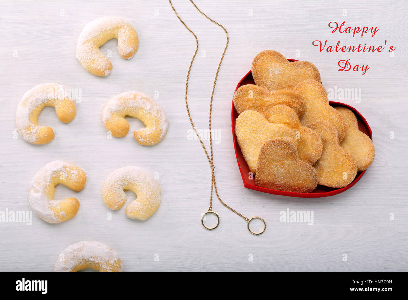 Delicious crunchy cookie in hearts shapes and inscription Happy Valentines Day Stock Photo