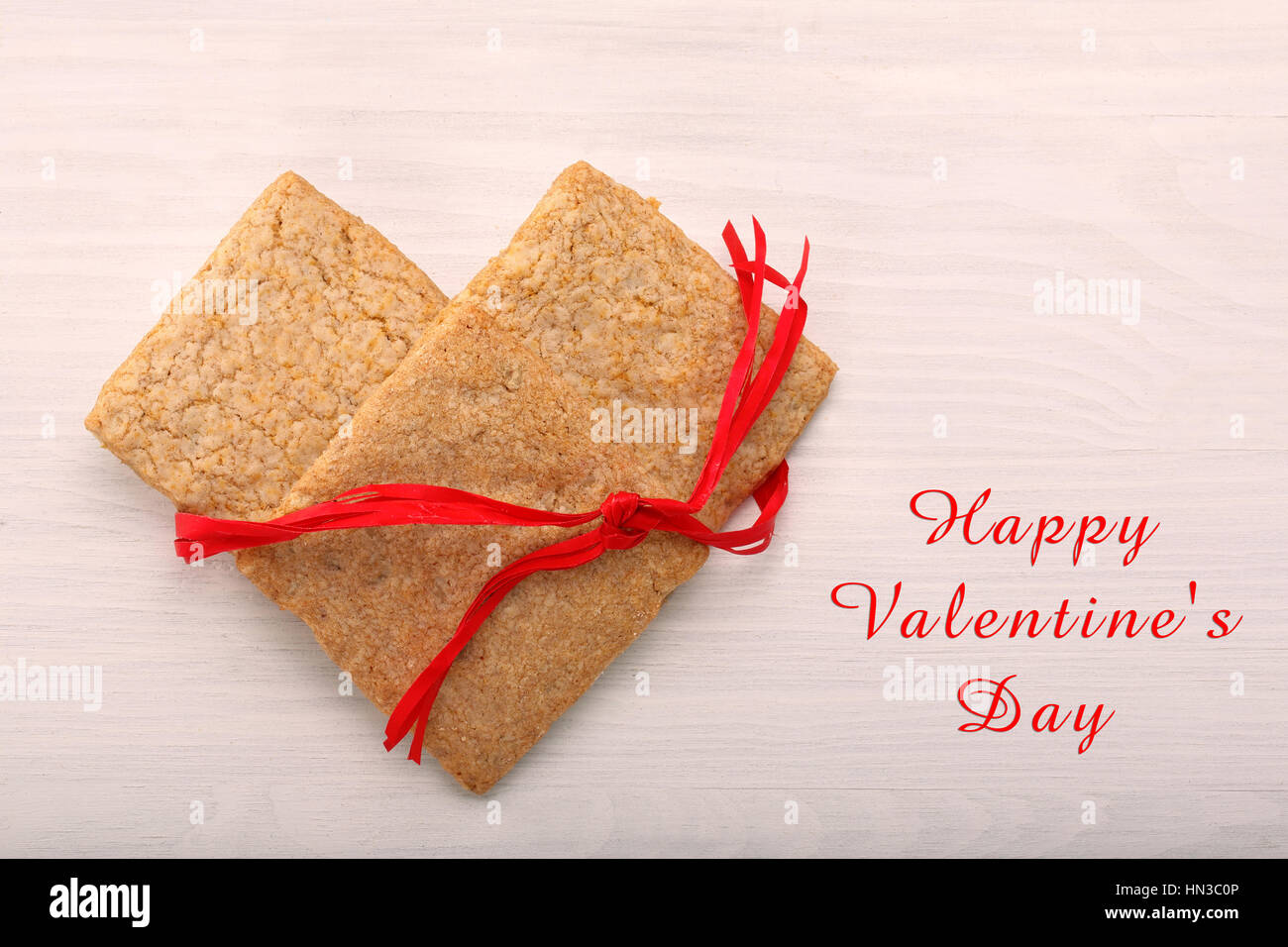 Delicious crunchy cookie in hearts shapes and inscription Happy Valentines Day Stock Photo