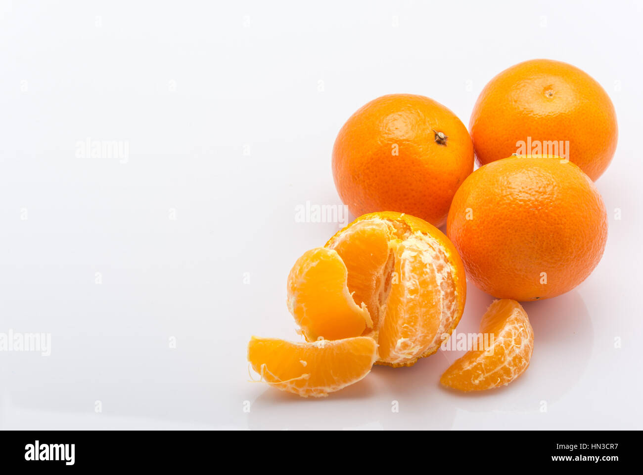 tangerines, peeled tangerine and tangerine slices on a white background Stock Photo