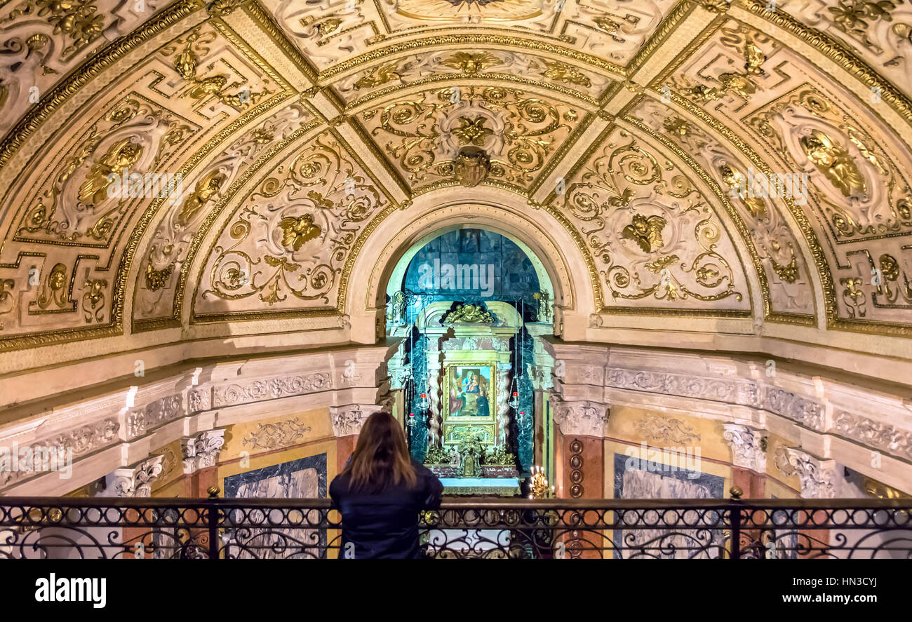 Turin, Italy January 2, 2016 woman praying inside Santuario della Consolata in Turin, Italy