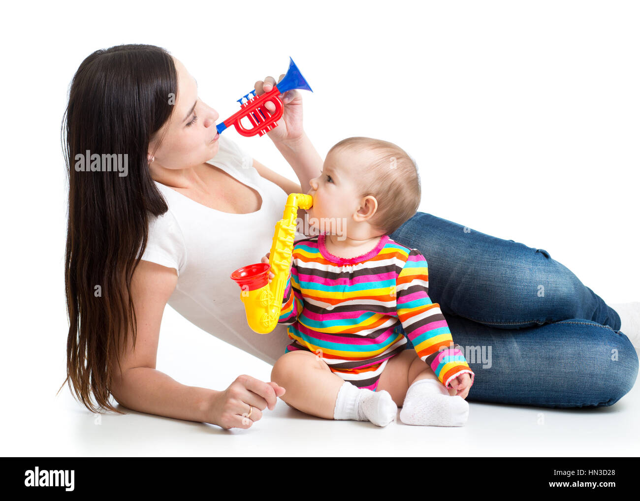 Mother and baby having fun with musical toys. Isolated on white background Stock Photo