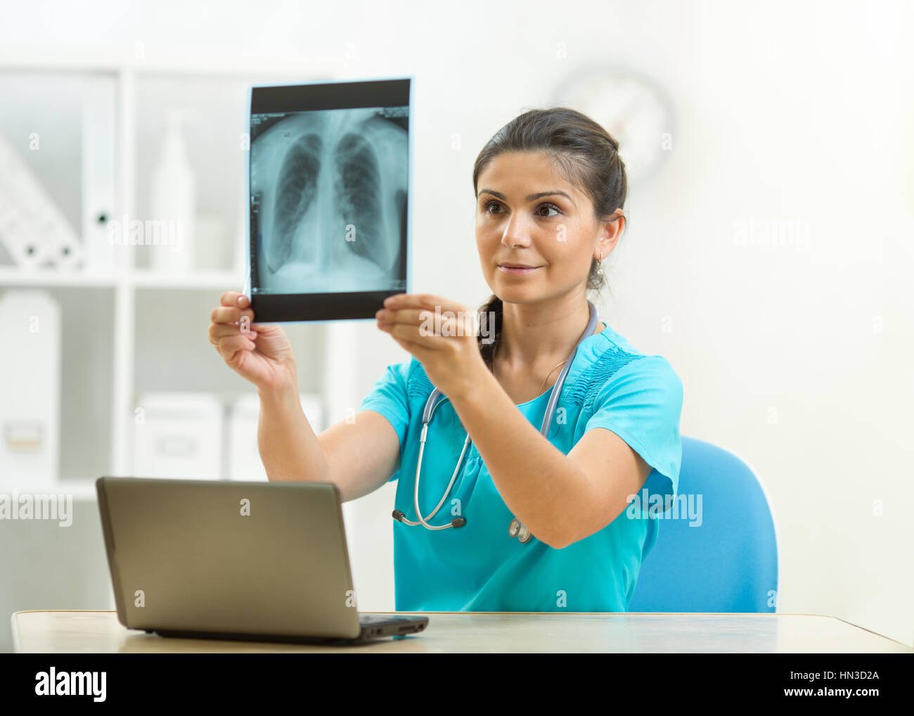 Young female doctor looking at the x-ray shot of lungs in hospital Stock Photo