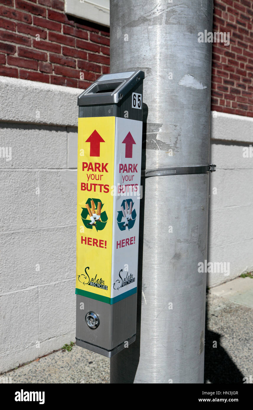 A lamp post mounted box for cigarette butts ('Park Your Butts') in Salem, Massachusetts, United States. Stock Photo