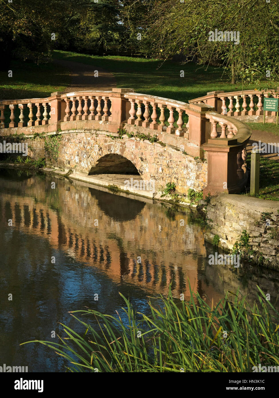 Terracotta stone bridge and lake, Castle Ashby Park and Gardens, Castle Ashby, Northamptonshire, England, UK Stock Photo