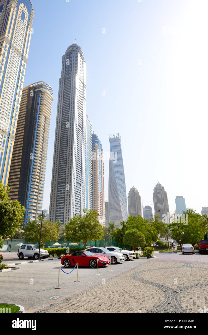 DUBAI, UAE - SEPTEMBER 11: The parking with sports cars and view on skyscrapers on September 11, 2013 in Dubai, United Arab Emirates. In the city of a Stock Photo