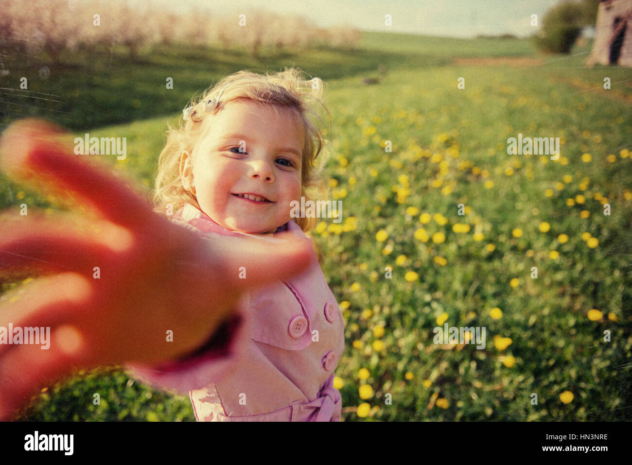 child playing on  sunny spring day. Toning effect. Stock Photo