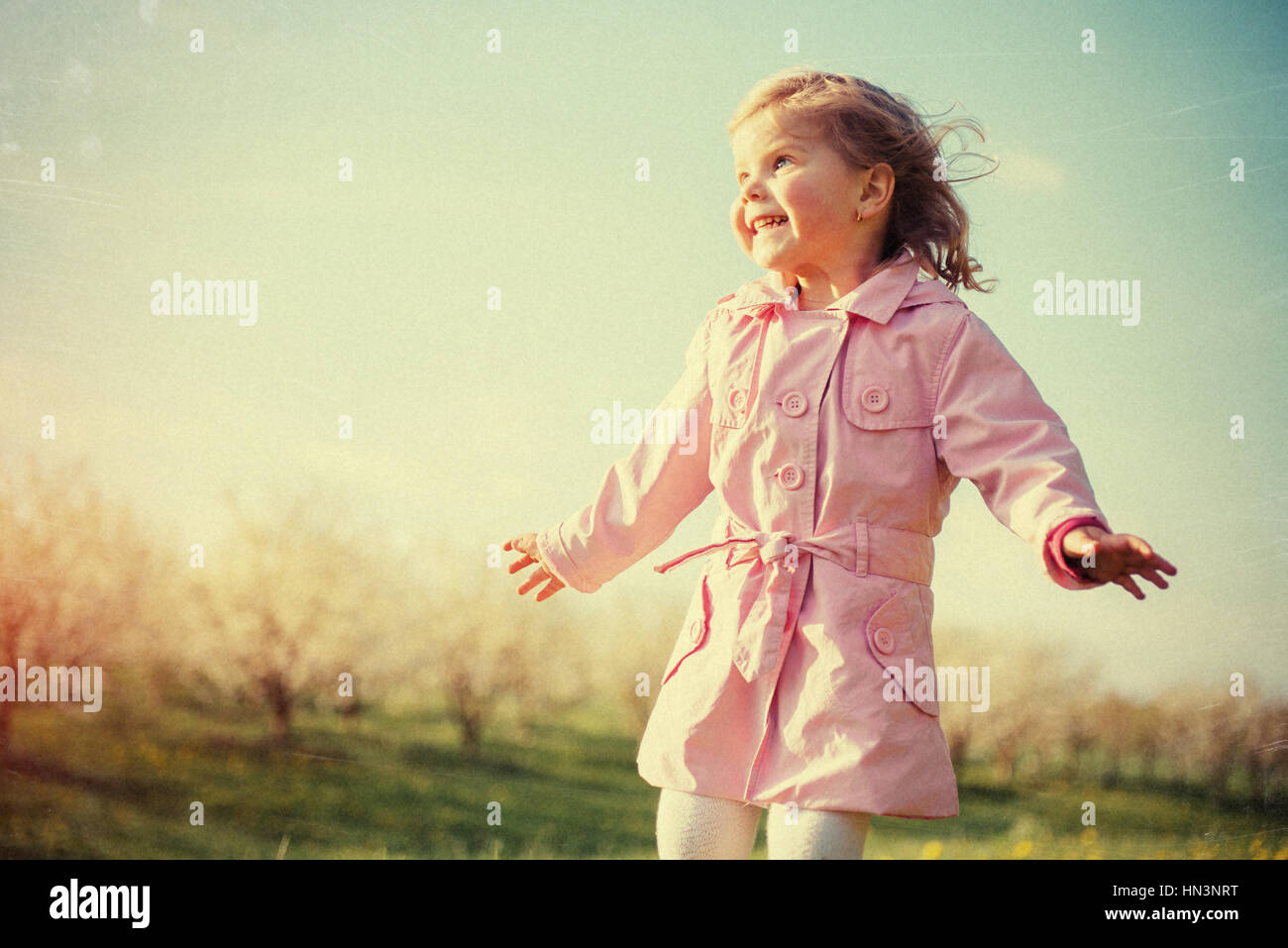 child playing on sunny spring day. Toning effect. Stock Photo