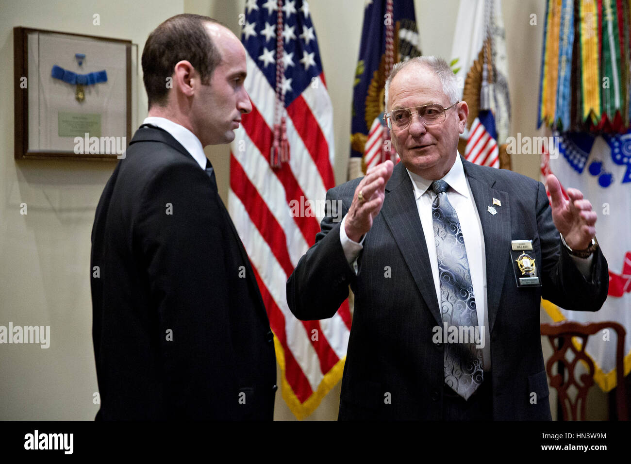 Washington DC, USA. 7th February 2017. John Aubrey, sheriff from Jefferson County, Kentucky, right, talks to Stephen Miller, White House senior advisor for policy, before the start of a listening session with U.S. President Donald Trump, not pictured, in the Roosevelt Room of the White House in Washington, DC, U.S., on Tuesday, Feb. 7, 2017. The Trump administration will return to court Tuesday to argue it has broad authority over national security and to demand reinstatement of a travel ban on seven Muslim-majority countries that stranded refugees, triggered protests and handed the young gove Stock Photo