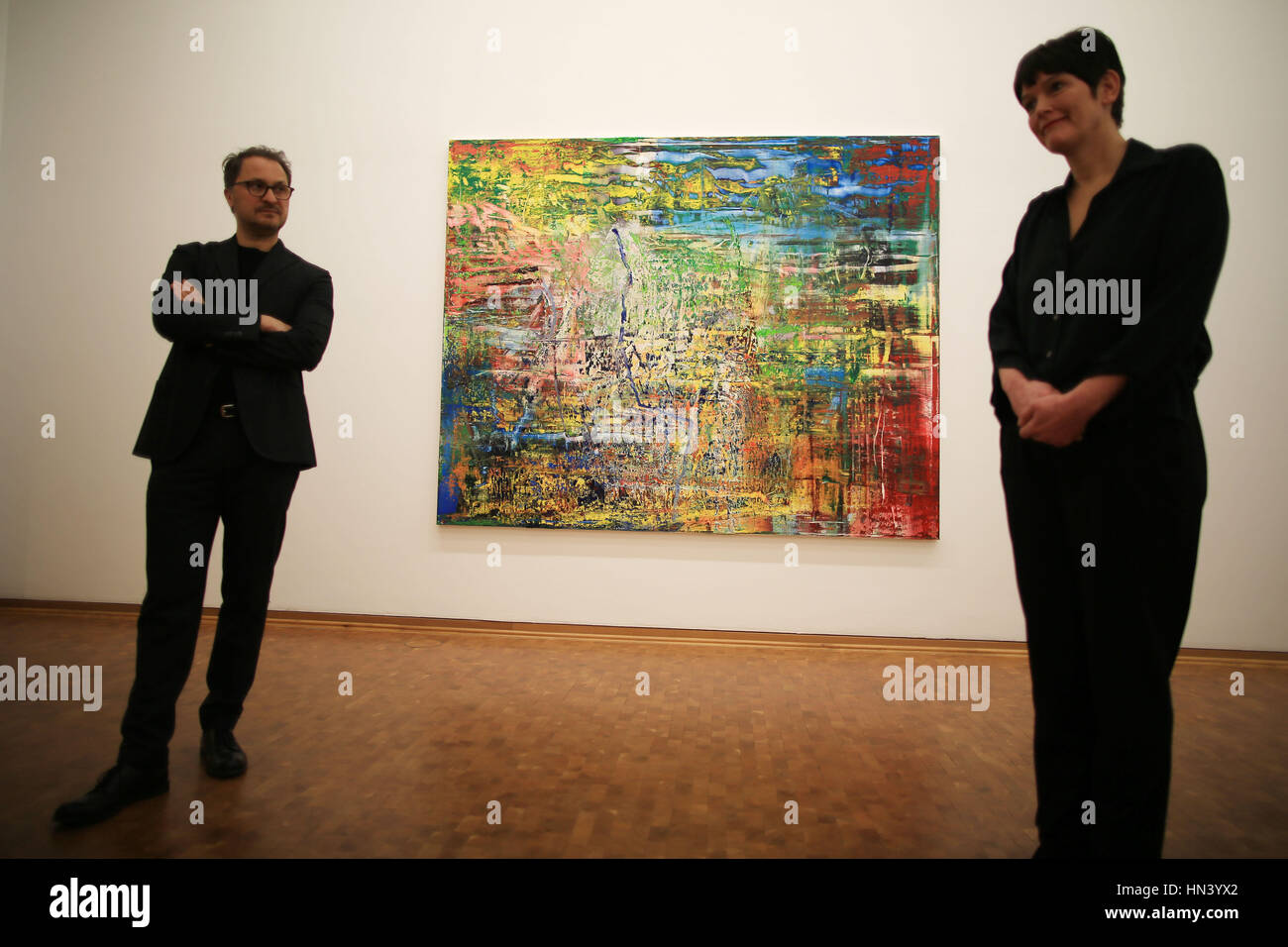Cologne, Germany. 7th Feb, 2017. The curator Rita Kersting and the director of the museum Ludwig Yilmaz Dziewior (L) speak in front of the painting 'Abstraktes Bild' from Gerhard Richter in Cologne, Germany, 7 February 2017. The exhibition 'New Pictures' for Richter's 85th birthday will be opened on the 9 February 2017 at the Museum Ludwig. Photo: Oliver Berg/dpa/Alamy Live News Stock Photo