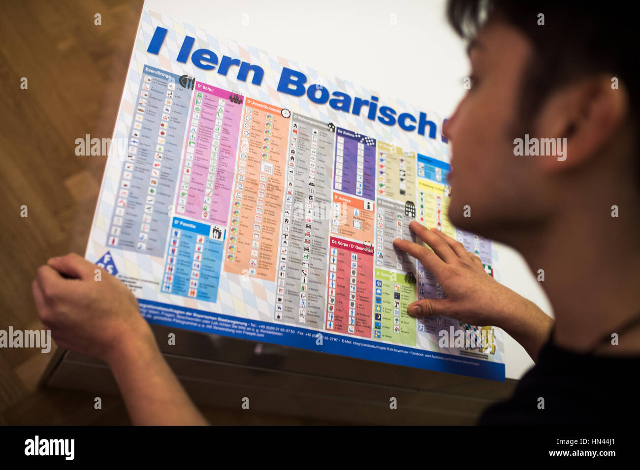 Munich, Germany. 7th Feb, 2017. ILLUSTRATION - A man reads a language ...