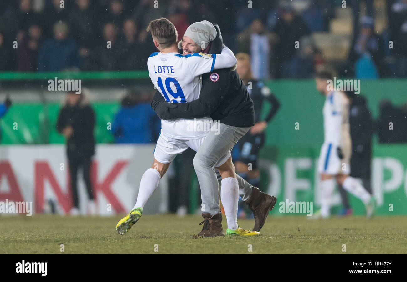 A Lotte fan has run onto the ground and embraced Lotte's Kevin Freiberger after the round of sixteen DFB Cup match between SF Lotte and TSV 1860 Munich at the FRIMO Stadium in Lotte, Germany, 8 February 2017. (EMBARGO CONDITIONS - ATTENTION: The DFB prohibits the utilisation and publication of sequential pictures on the internet and other online media during the match (including half-time). ATTENTION: BLOCKING PERIOD! The DFB permits the further utilisation and publication of the pictures for mobile services (especially MMS) and for DVB-H and DMB only after the end of the match.) Photo: Gui Stock Photo