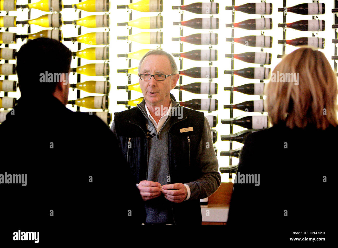 Napa, CA, USA. 2nd Feb, 2017. Etude Winery Hospitality Specialist Robert Atkins, center, chats with Victor, left, and Amavely Alvarez, both of Santa Clara, in the tasting room on Thursday afternoon. Credit: Napa Valley Register/ZUMA Wire/Alamy Live News Stock Photo