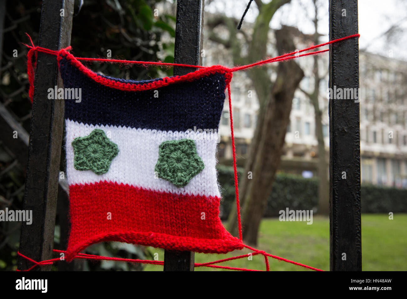 London, UK. 8th February, 2017. A small knitted Syrian flag appears outside the US embassy in Grosvenor Square in protest against the temporary barring from entry to the United States, by means of an executive order made by President Donald Trump, of citizens of Iran, Iraq, Libya, Somalia, Sudan, Syria and Yemen. Credit: Mark Kerrison/Alamy Live News Stock Photo