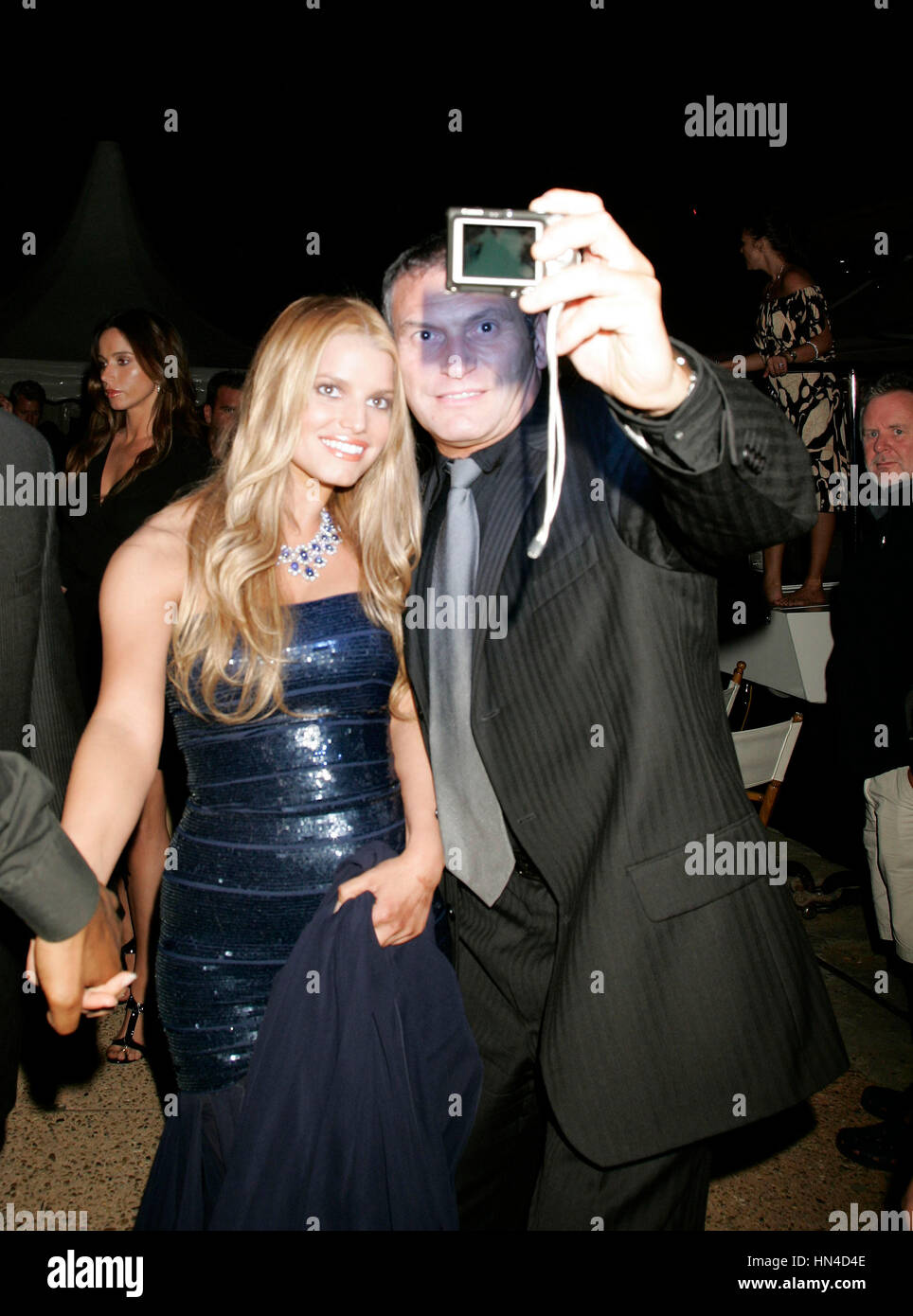 Jessica Simpson takes a photo with a fan at a party at the Cannes Film Festival in Cannes, France, on Friday, May 18, 2007. Photo credit: Francis Specker Stock Photo