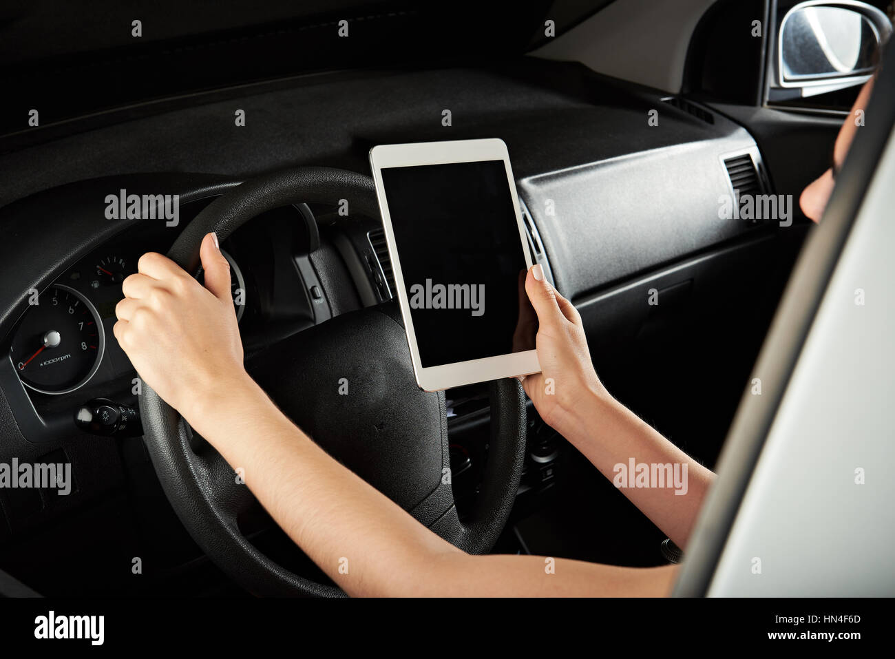 girl using tablet while driving isolated on black Stock Photo Alamy