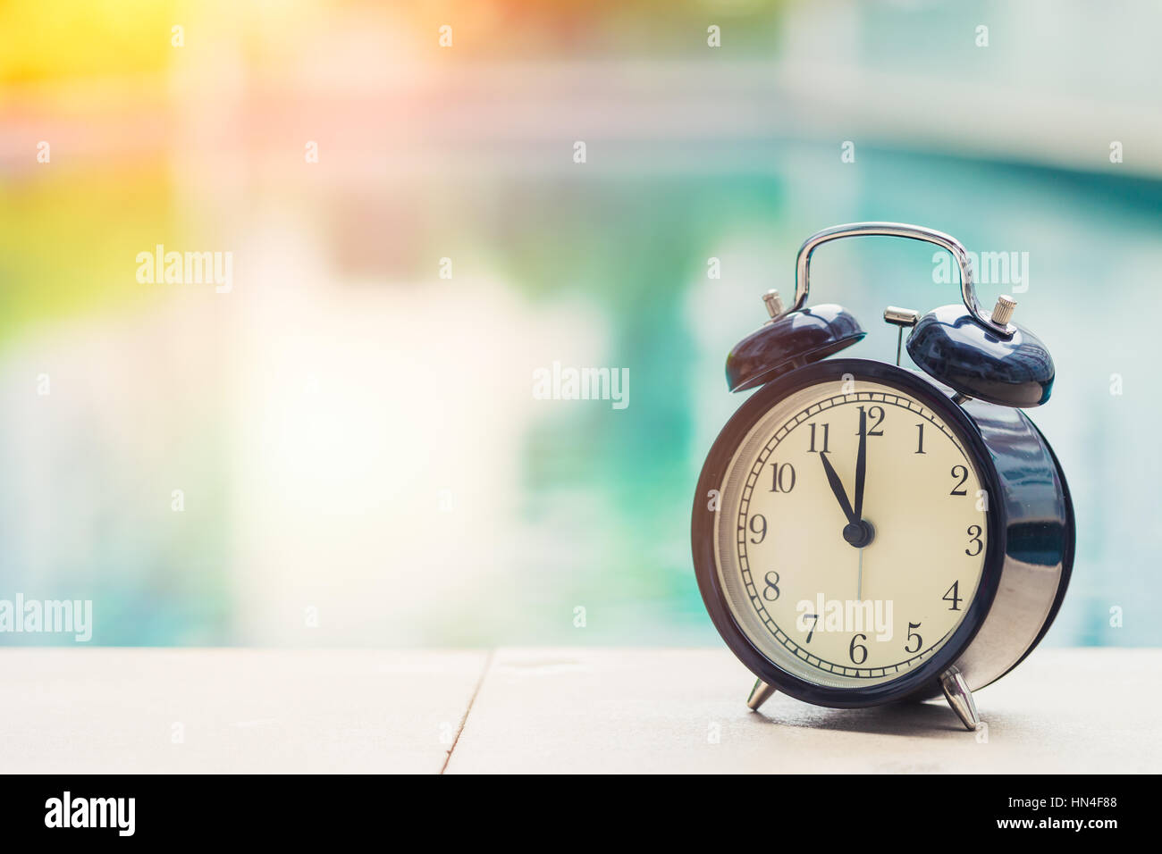 11 o'clock retro clock at the swimming pool outdoor holiday time concept. Stock Photo
