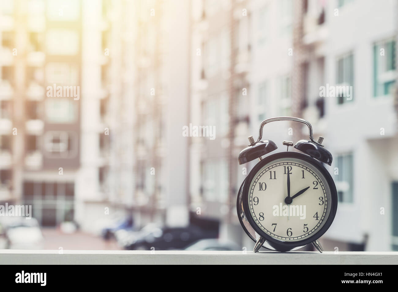 2 o'clock retro clock with The Clock condominium background Stock Photo ...