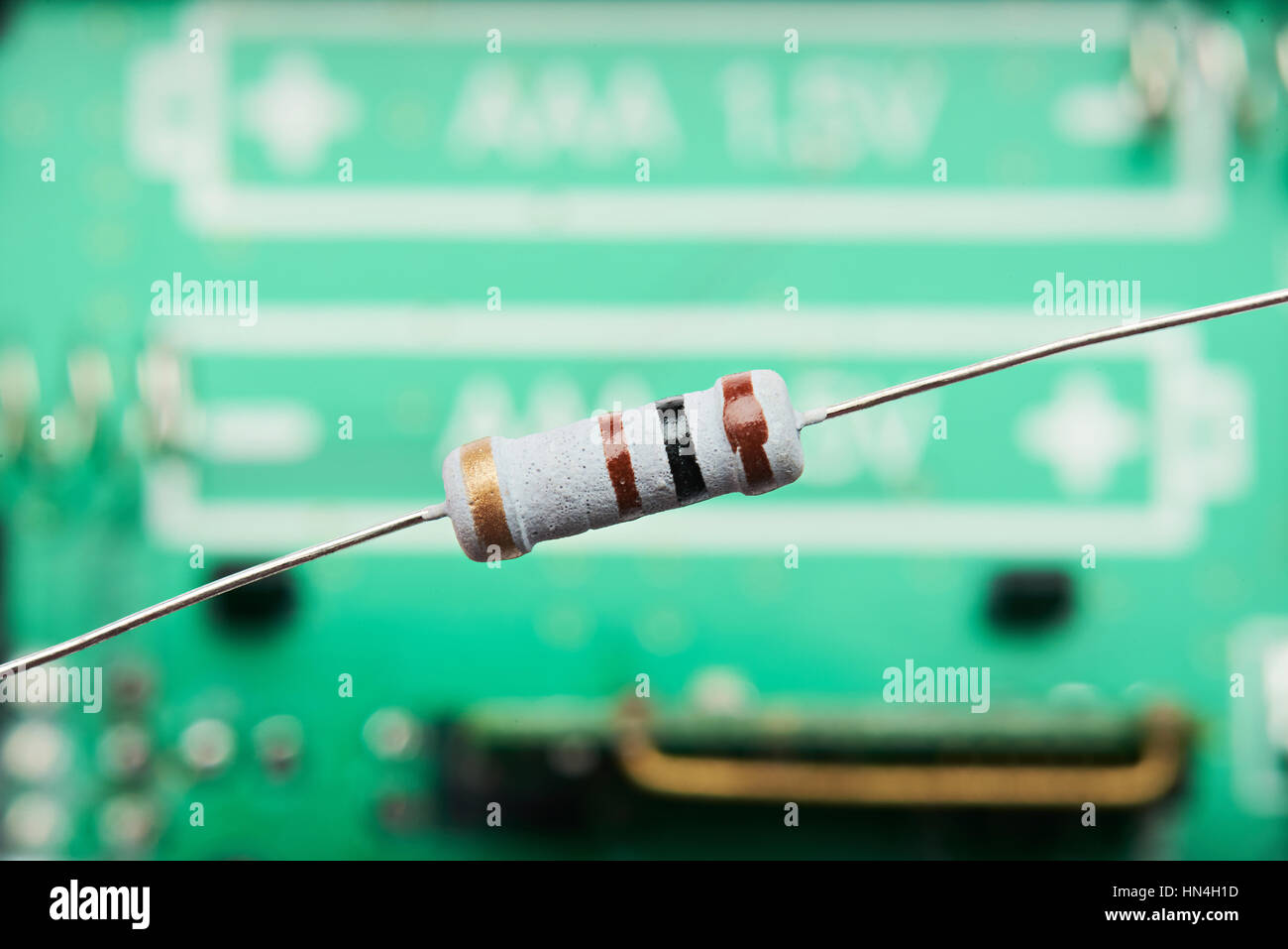 one round small resistor on electrical circuit background Stock Photo