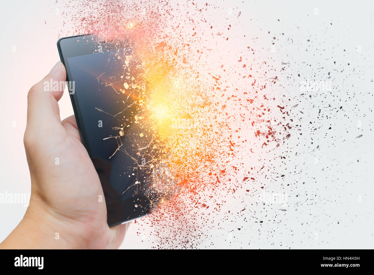 smartphone explosion, blow up cellphone battery or explosive mobile phone or explode burst fire burn out smart device with dispersion effect. Stock Photo