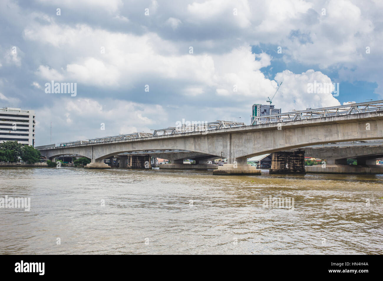 concrete bridge across the river. Stock Photo