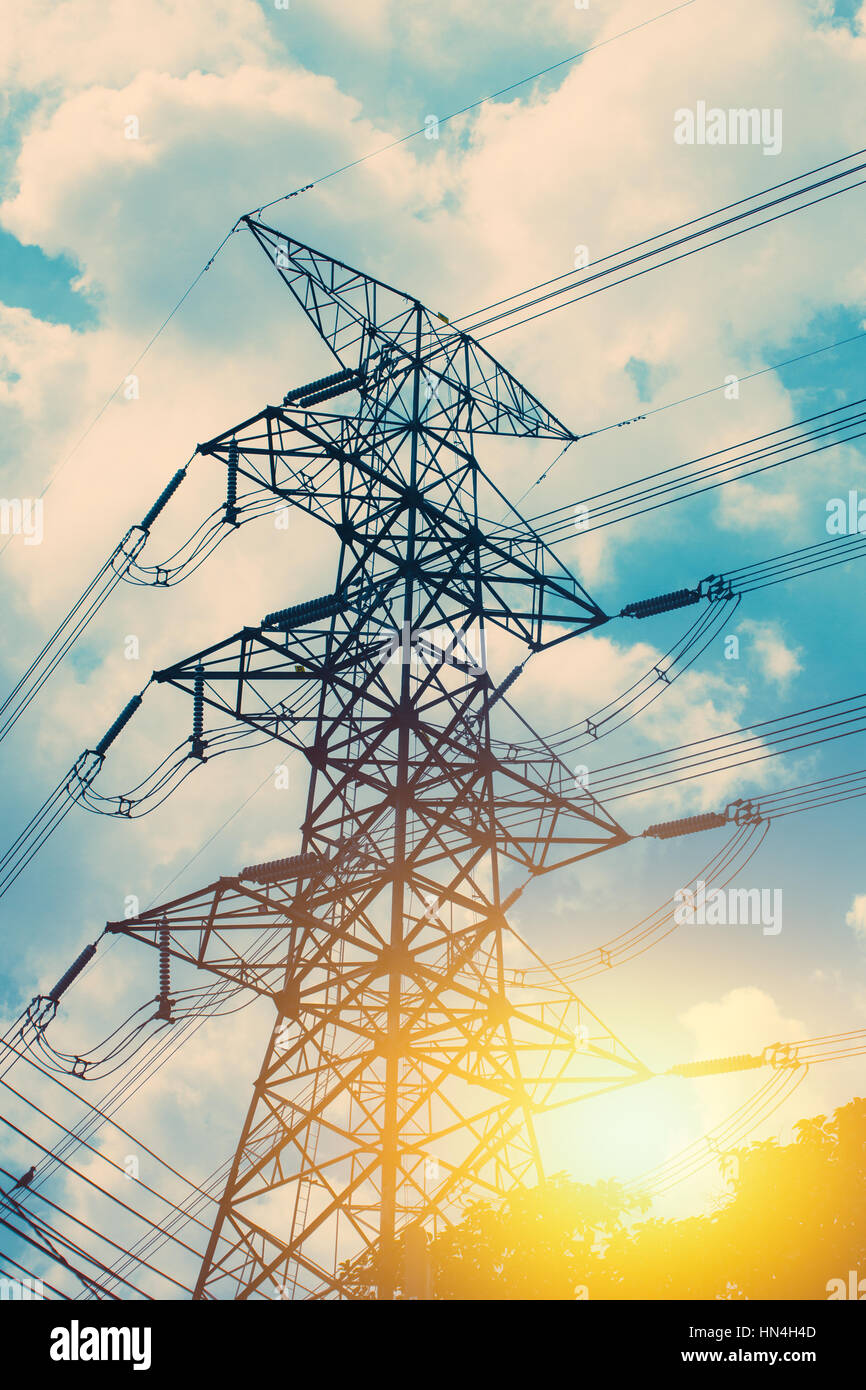 High voltage cable power post steel tower pylons in sunset scene ...