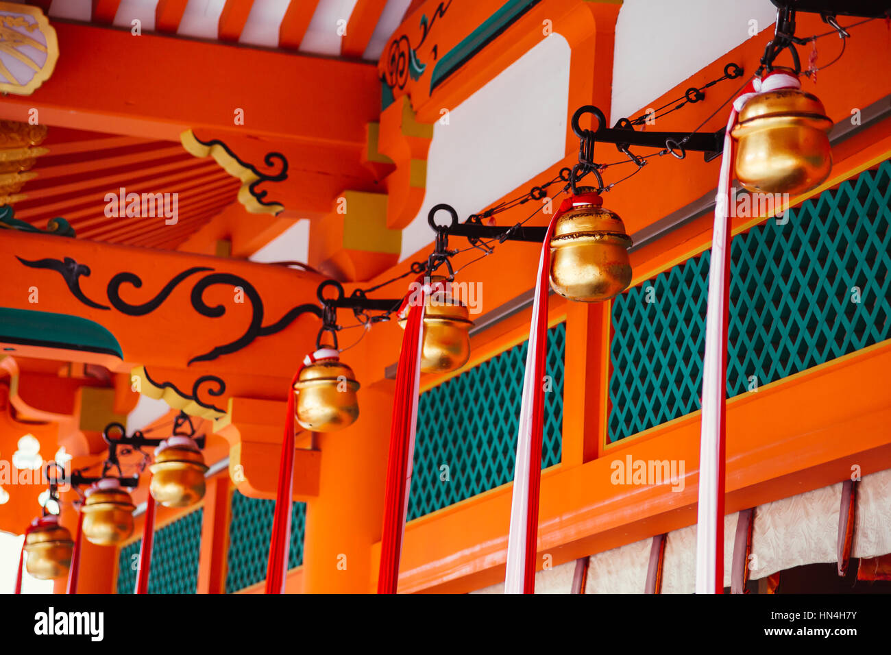 Suzu or Golden bell in Japanese shrine hanging under the eaves of a Shinto shrine. Stock Photo