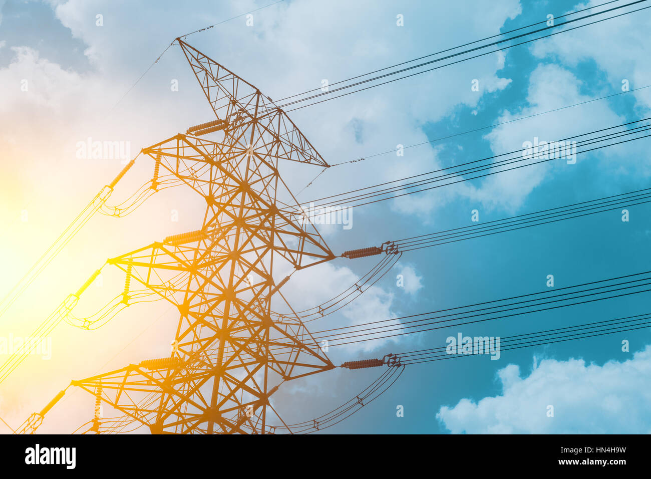 High voltage cable power post steel tower pylons in sunset scene ...