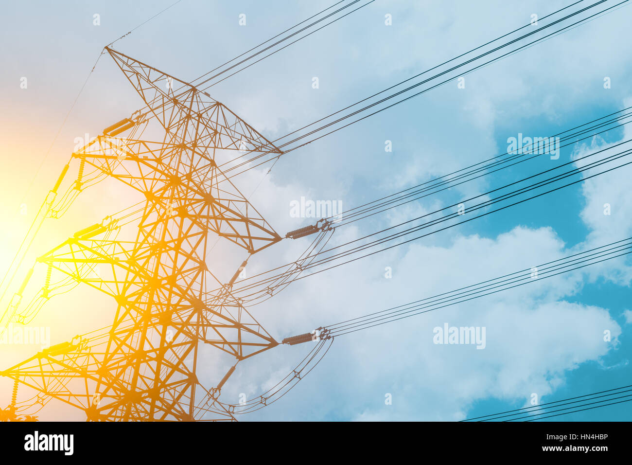 High voltage cable power post steel tower pylons in sunset scene ...